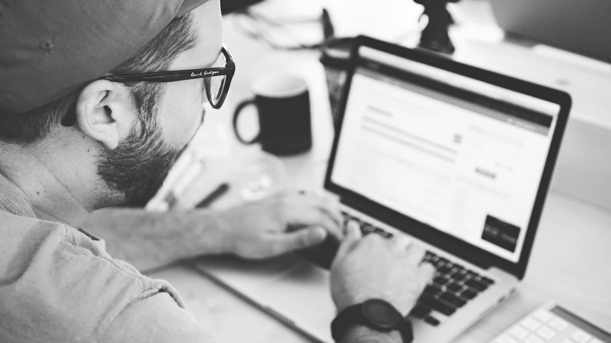 Man updating his blog on laptop