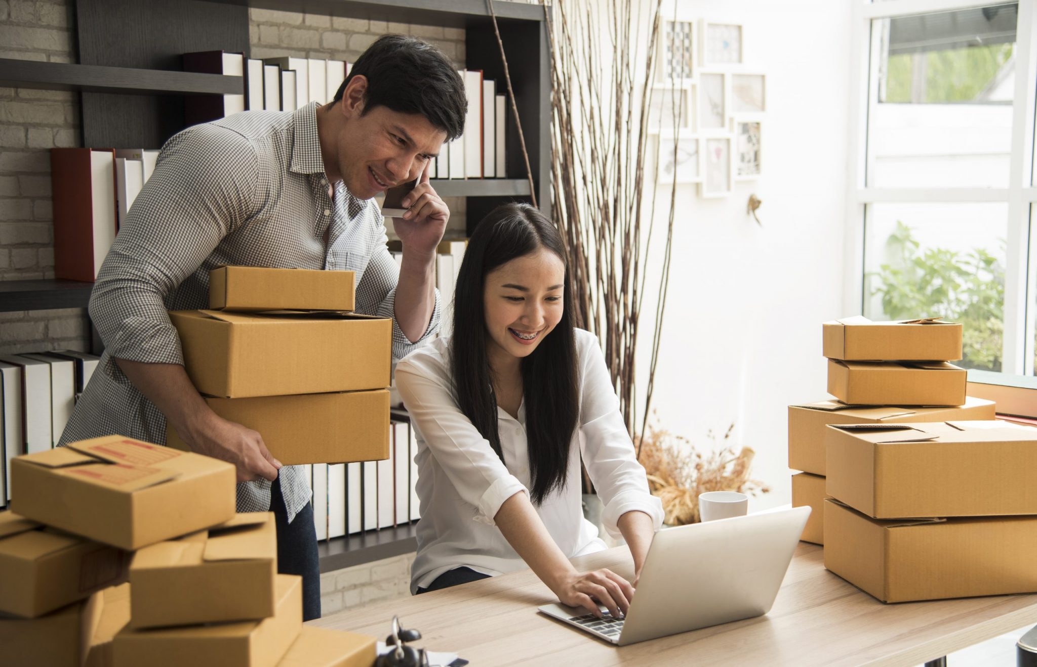 Man and woman looking at laptop doing business